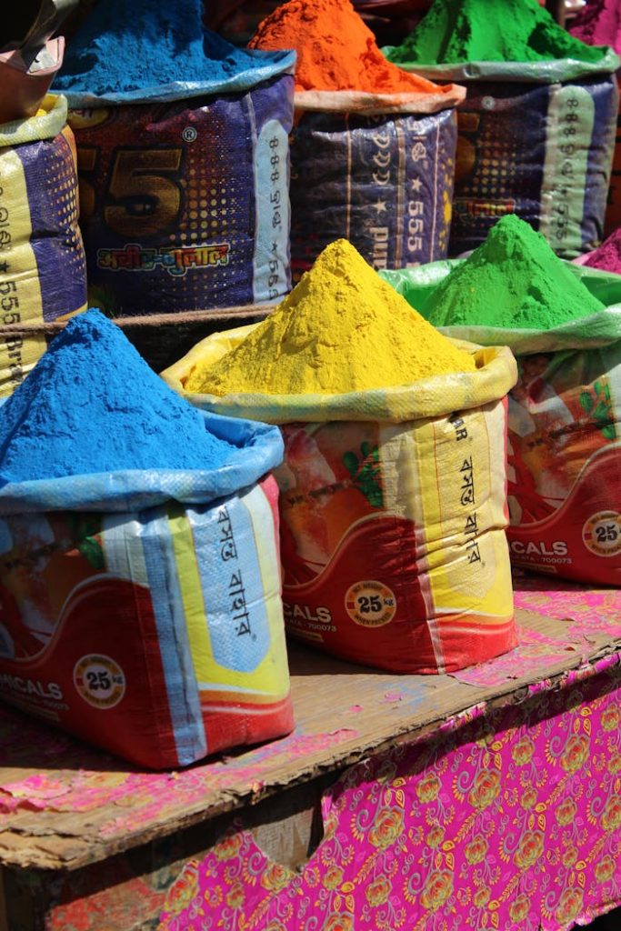 Colorful Holi powder bags at an Indian market, perfect for festivals.