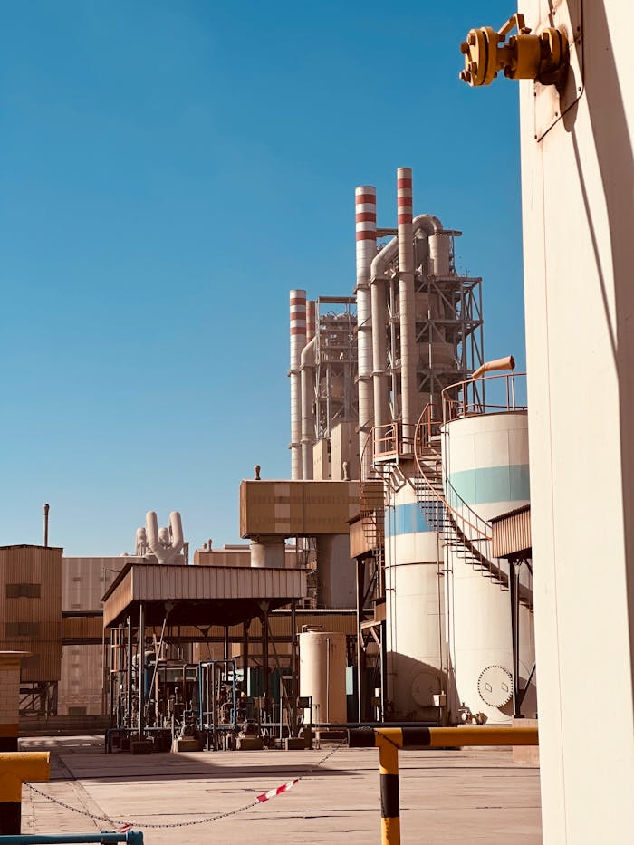 A sprawling cement factory under clear blue skies in Saudi Arabia
